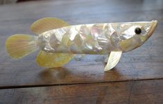 a plastic fish that is sitting on a table