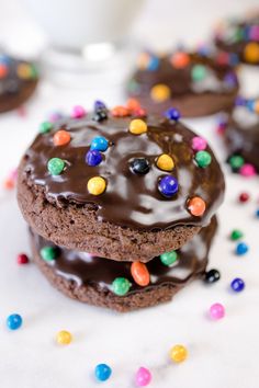 chocolate cookies with m & m on top and sprinkles all around them