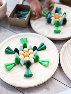 three wooden plates with green and white decorations on them, one is made out of candy