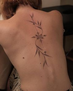 a woman with a tattoo on her back