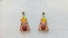 Looking for a fun and unique addition to your jewelry collection? Check out these adorable capybaras and Orange Dangle Earrings! Handmade with love and attention to detail, these earrings feature a cute Capybara design in a vibrant orange color that's sure to turn heads. * Lightweight and comfortable for all-day wear * Perfect for animal lovers and wildlife enthusiasts * Great gift idea for birthdays, holidays, or any special occasion * Free shipping on orders over $35 Show your love for animals and wildlife while getting COMPLEMENTS with these one-of-a-kind earrings! Buy $35 to get free shipping :) Available with Clip ons Have an amazing day 🤩 Animal Design Dangle Earrings As Gift, Cute Brown Dangle Earrings, Playful Animal Design Jewelry Gift, Adjustable Animal Design Earrings As Gift, Handmade Novelty Earrings For Everyday, Cute Brown Earrings As Gift, Cute Brown Earrings Gift, Cute Brown Earrings For Gift, Cute Handmade Brown Jewelry