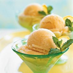 two small bowls filled with lemon souffle and garnished with mint leaves