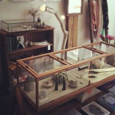 a display case filled with jewelry on top of a table