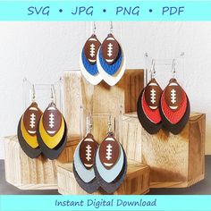 the football earrings are made out of wood and have different colors, shapes and sizes