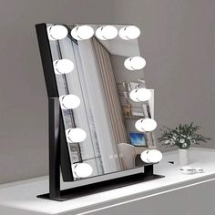 a vanity mirror with lights on top of it