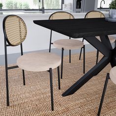 a dining table with four chairs around it