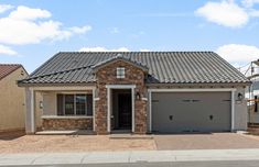 a brick house with two garages in the front and one attached to it's side