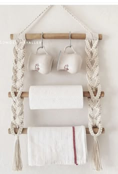 the bathroom is decorated in white and has two hanging towels, one with tassels on it