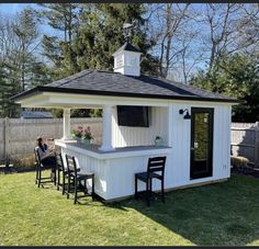 a woman sitting at a bar in the back yard