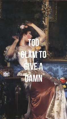 a woman sitting on top of a blue couch in front of a painting with the words too glam to give a damn