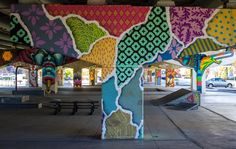 an art installation in the middle of a parking lot with multiple colored designs on it