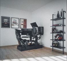 a room with some shelves and pictures on the wall