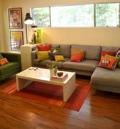 a living room with two couches, a coffee table and pictures on the wall