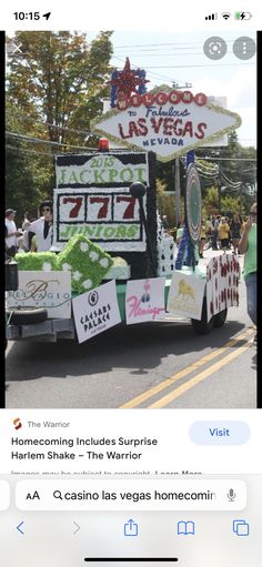 an image of a truck driving down the street with signs on it's side