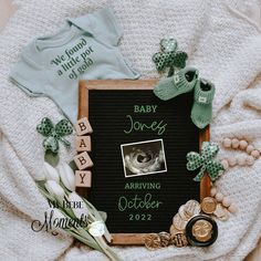 a baby announcement is displayed on top of a blanket with other items and decorations around it