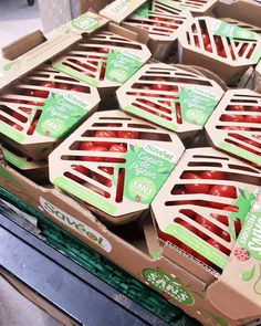 several boxes of strawberries are stacked on top of each other in a grocery store