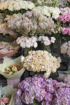 several vases filled with different types of flowers