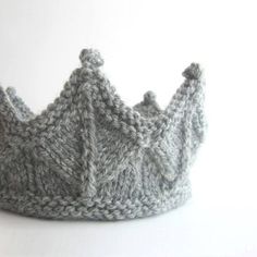 a knitted crown sitting on top of a white table