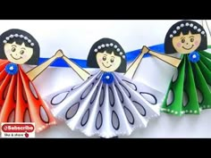 three paper dolls are holding hands in the air