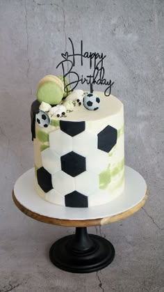 a soccer themed birthday cake on a pedestal