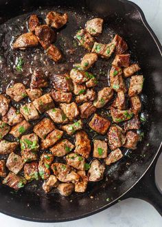 some meat is cooking in a skillet on the stove top and it looks like they have just been cooked