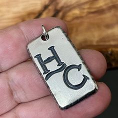 These custom made, sterling silver, ranch brand necklaces are simply amazing and make the perfect gift for men who are proud to display their cattle or livestock brand. These personalized dog tag/pendant necklaces are hand carved and engraved/hand stamped and personalized just for him with his brand and additional text, if wanted. They are handsome, masculine, maximal and rugged. Meaningful jewelry for him. Perfect. Women's ranch brand jewelry is also available in our shop. These make the perfec Silver Engraved Jewelry, Silver Engraved Jewelry For Everyday, Sterling Silver Dog Tag Jewelry With Engraving Option, Southwestern Engraved Necklace For Gift, Stamped Sterling Silver Nameplate Jewelry, Western Style Silver Engraved Necklace, Southwestern Silver Engraved Necklaces, Sterling Silver Etched Dog Tag Jewelry, Cow Tag Necklace For Men