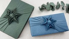 two folded paper stars sitting next to each other