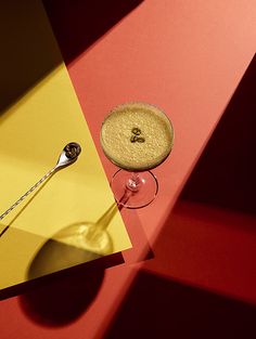 a spoon sitting on top of a yellow and red table