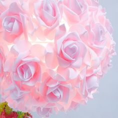 a vase with pink flowers in it sitting on a table