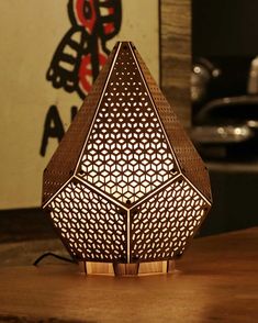 an intricately designed lamp on a wooden table