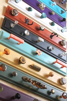 a bunch of different colored drawers with knobs on them