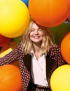 a woman standing in front of balloons with her hands on her hips