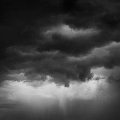 a black and white photo of storm clouds