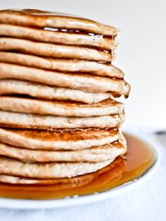 a stack of pancakes on a plate with syrup