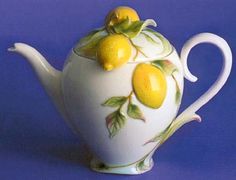 a tea pot with lemons painted on it