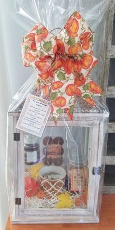 a clear box filled with food and wrapped in cellophane on top of a wooden table