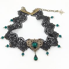 This vintage gothic styled crystal lace choker necklace features lush Emerald Swarovski crystals with nice crisp facets and brass embellishments. The detailed stampings have been in production since the 1940's and the vintage 16x11mm focal crystal is no longer in production, making this necklace a rare find.Both elegant and stylish, this piece would be perfect for any formal occasion.Swarovski Crystals are made in Austria and are the highest quality lead free glass-cut crystals on the market, wi Vintage Jeweled Choker As Gift, Vintage Jeweled Choker Gift, Vintage Metal Choker With Jewels, Vintage Jeweled Choker, Ornate Party Choker Jewelry, Vintage Jeweled Choker For Parties, Vintage Metal Choker For Wedding, Victorian Metal Choker For Gift, Victorian Metal Choker As Gift