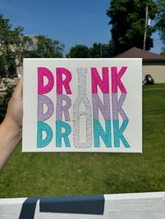 someone holding up a card with the words drink drunk in pink, blue and green