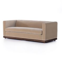 a brown couch sitting on top of a white floor