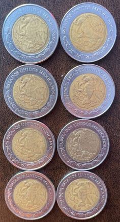 ten british pound coins sitting on top of a table