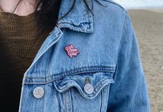 a close up of a person wearing a jean jacket