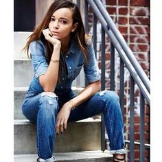 a woman sitting on the steps talking on her cell phone