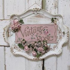 a sign that says vintage rose with flowers on it