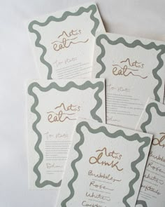 four wedding cards with gold lettering on them