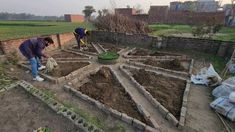 two people are working in the garden with dirt and grass on the ground, one is digging