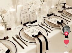 the table is set with black and white place settings