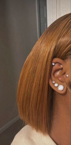 a close up of a person with ear piercings on their ears and behind the ear