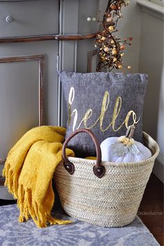 a basket filled with items sitting on top of a rug next to a yellow blanket