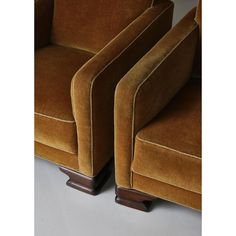 two brown chairs sitting next to each other