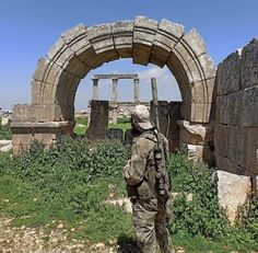 a man standing in front of some ruins